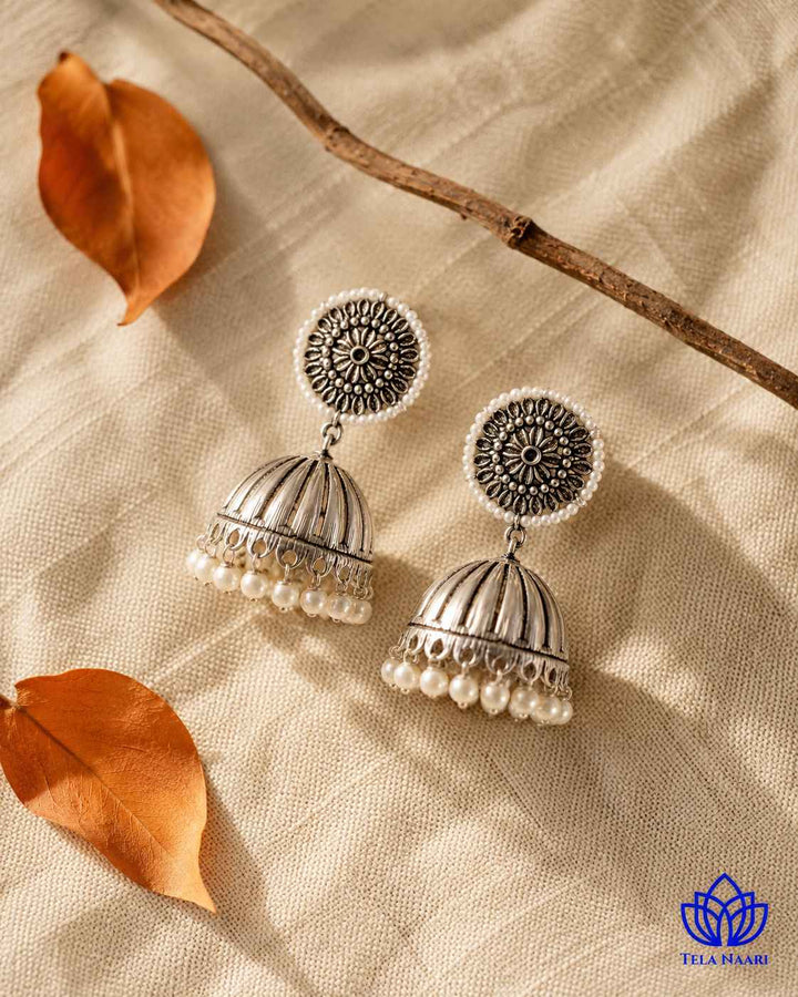 Delicate glass bead detailing decorates the surface of this earring.