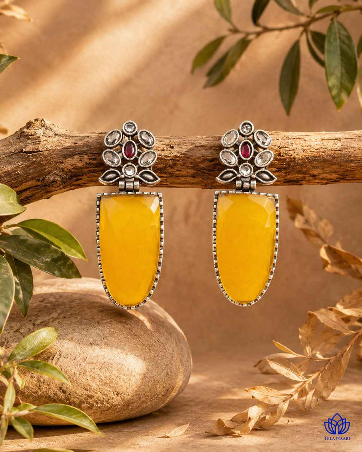 Brass construction supports the bold plated design of this earring.