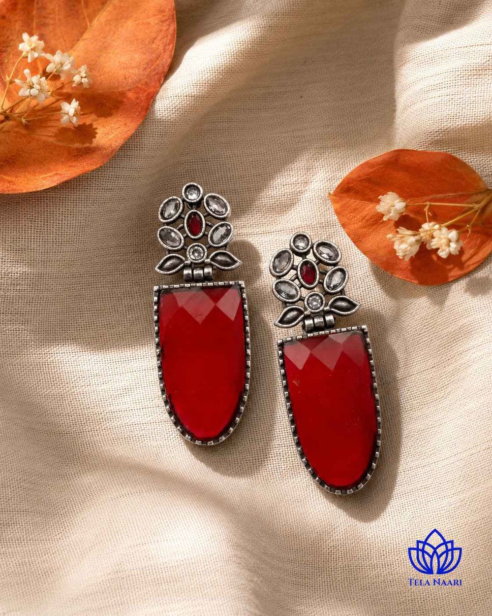 Idai brings a bold silhouette to this red statement earring.