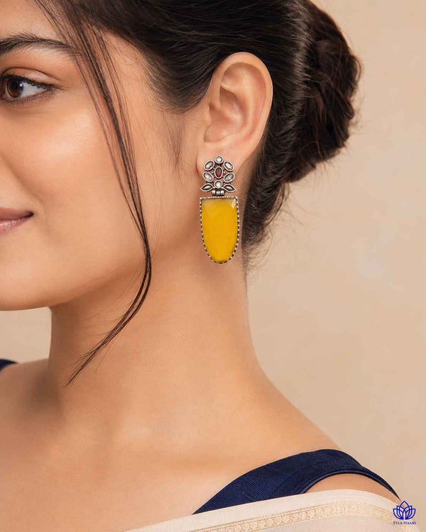 Bold silver-plated earring features a striking, lustrous statement silhouette.