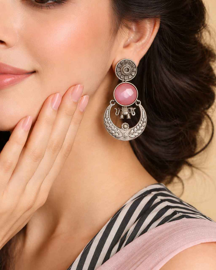 Ornate stone detailing decorates the surface of this earring.