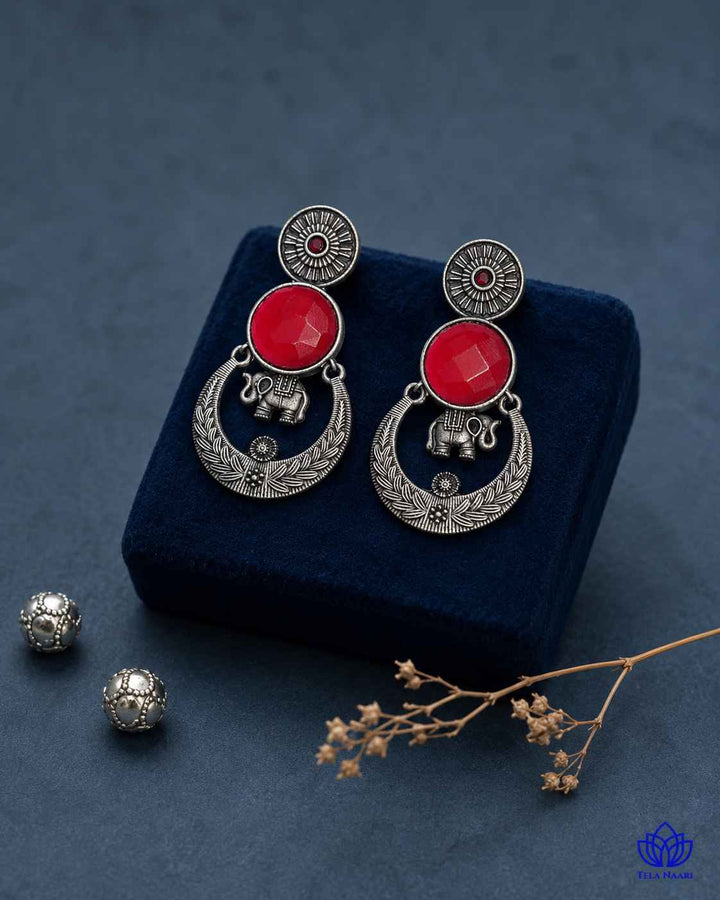 Brass construction supports the stone detailing of this earring.