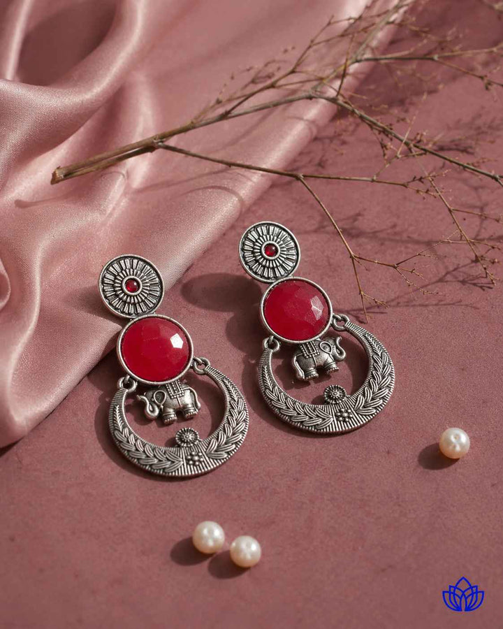 Glass bead accents add texture to this red stone earring.