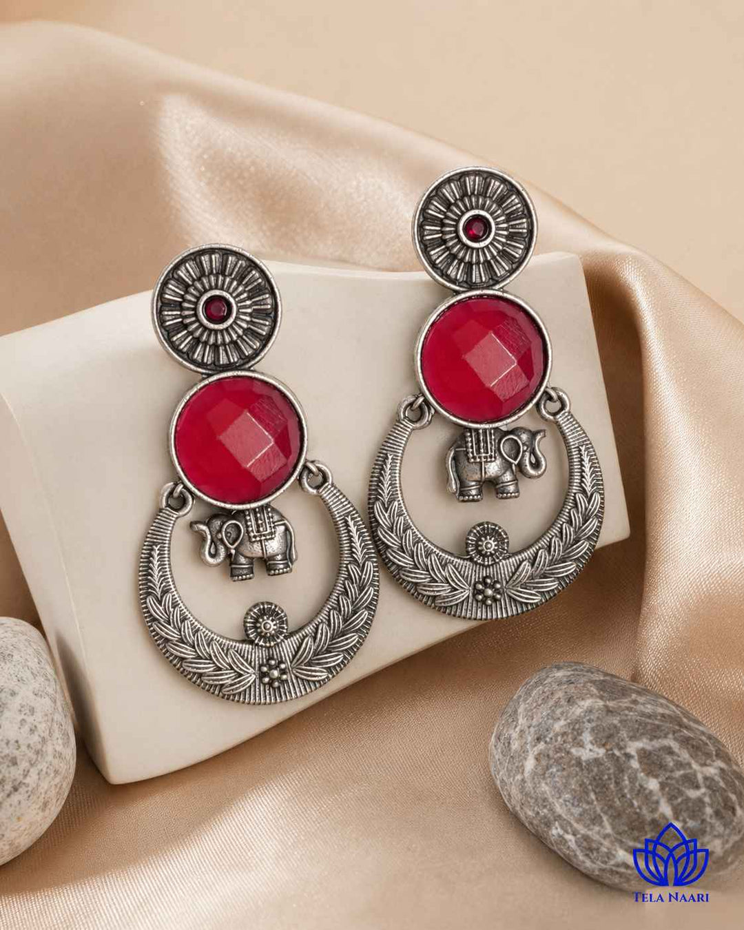 Textured surface combines glass beads with red stone detailing.