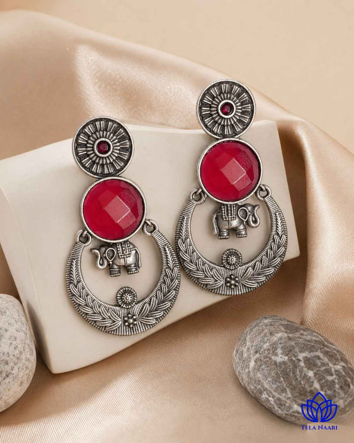 Textured surface combines glass beads with red stone detailing.
