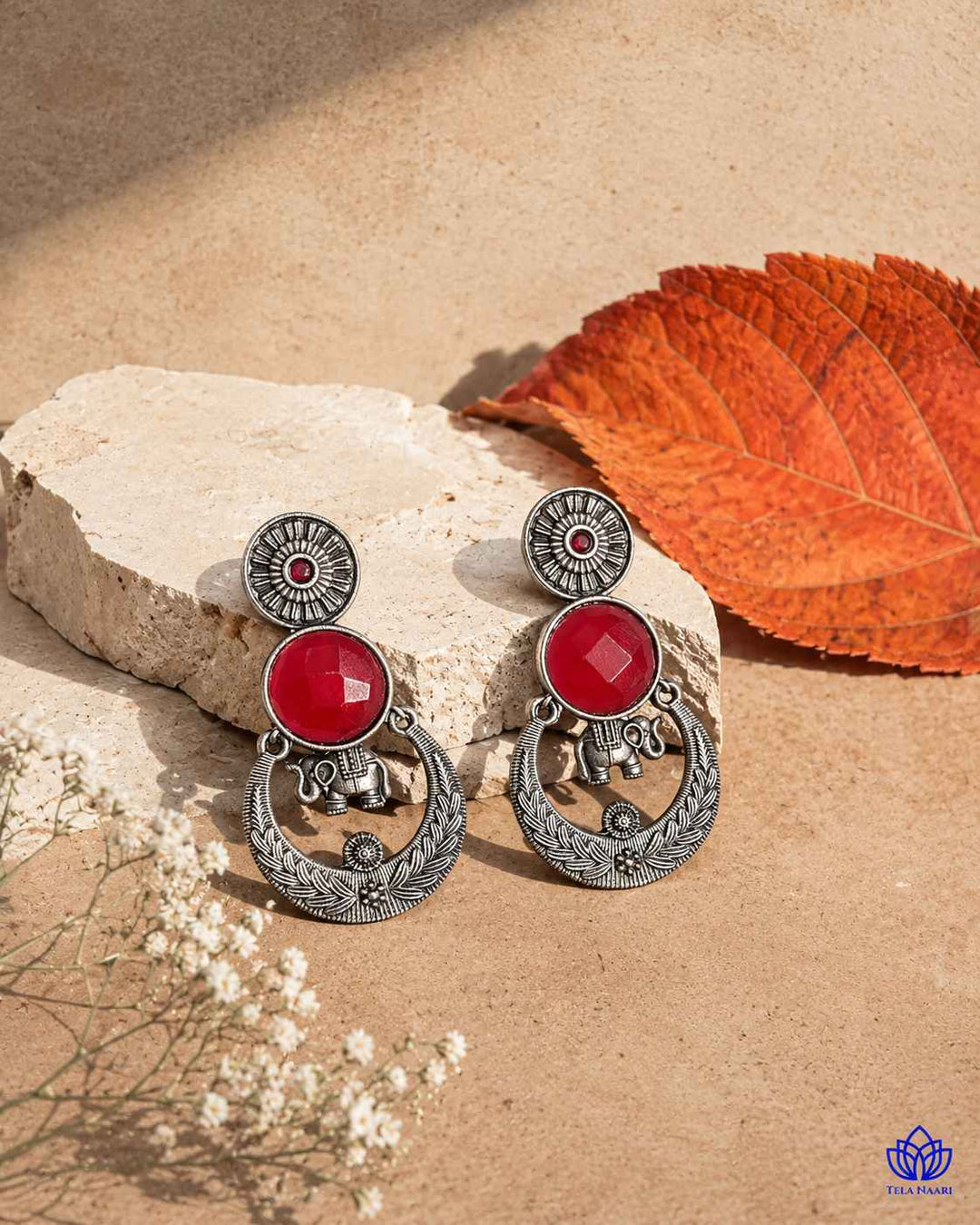 Versatile design pairs a silver-plated finish with red stones.