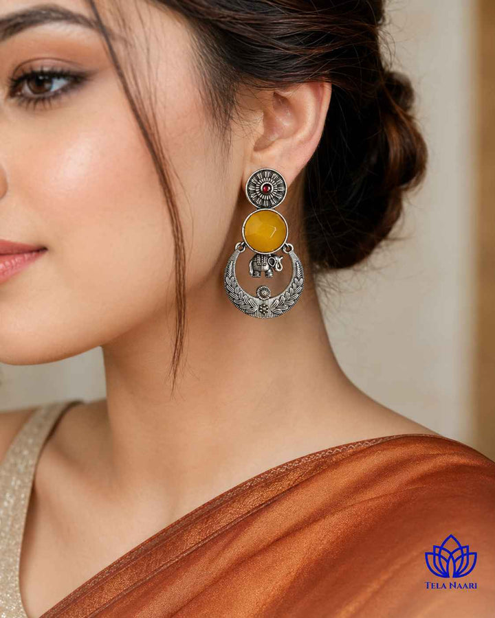Golden yellow stone shapes the silhouette of this earring.