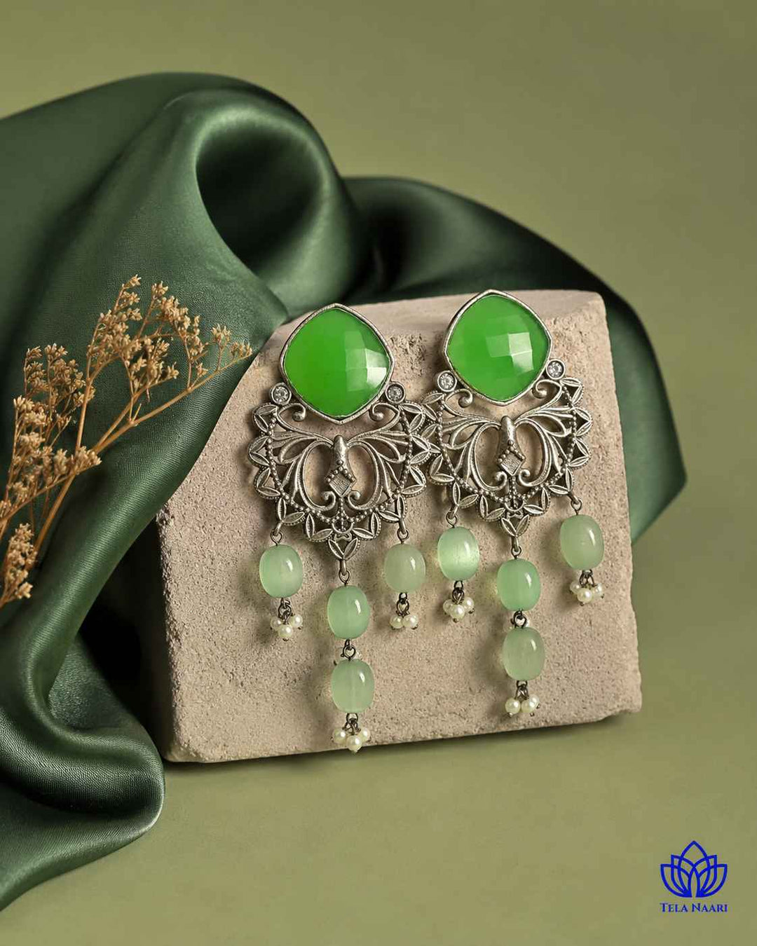 Brass construction supports the lightweight dangler design of this earring.