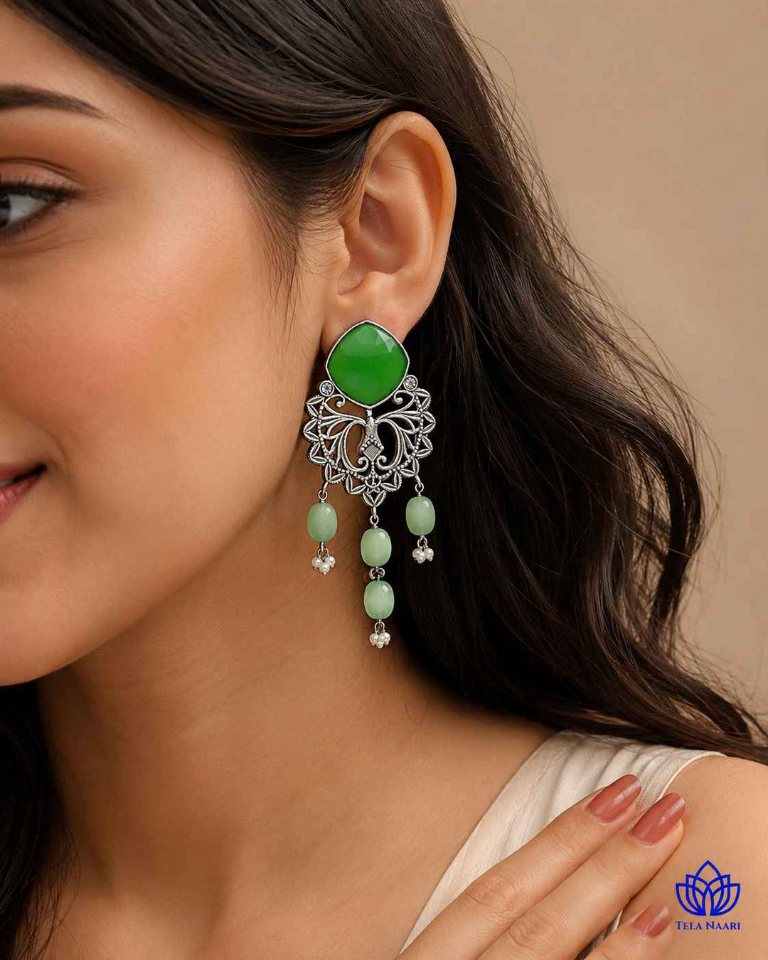 Delicate stone work highlights the design of this dangler earring.