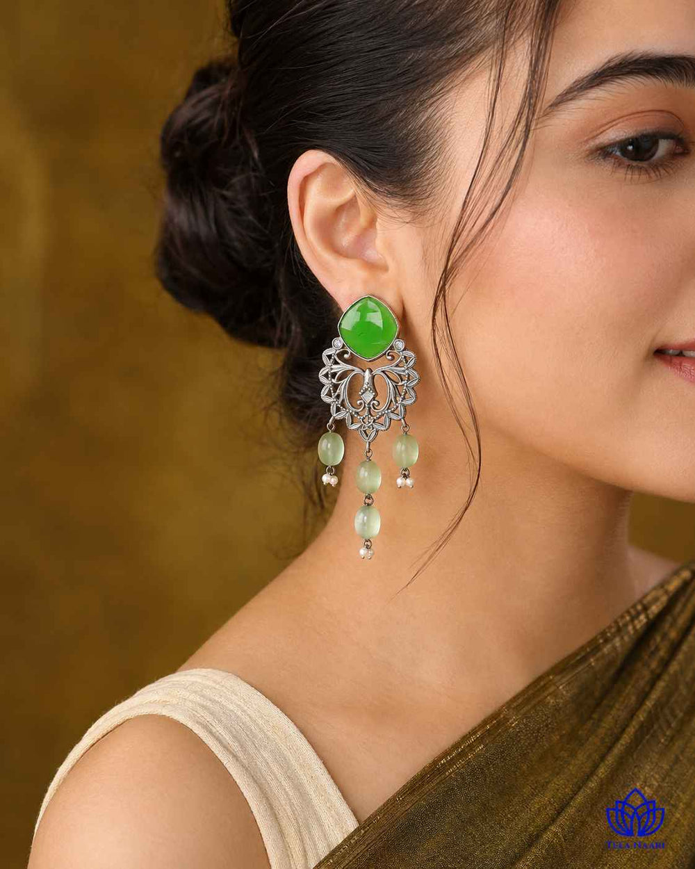 Silver-plated finish covers the surface of this dangler earring.