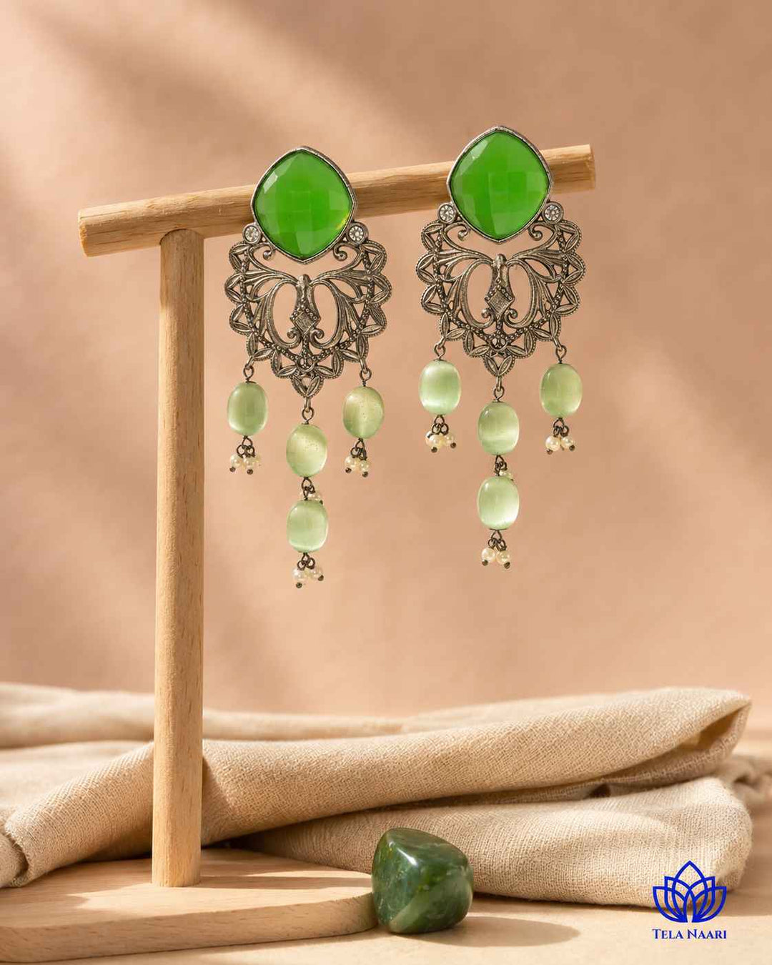 Textured surface combines glass beads with green stone detailing.