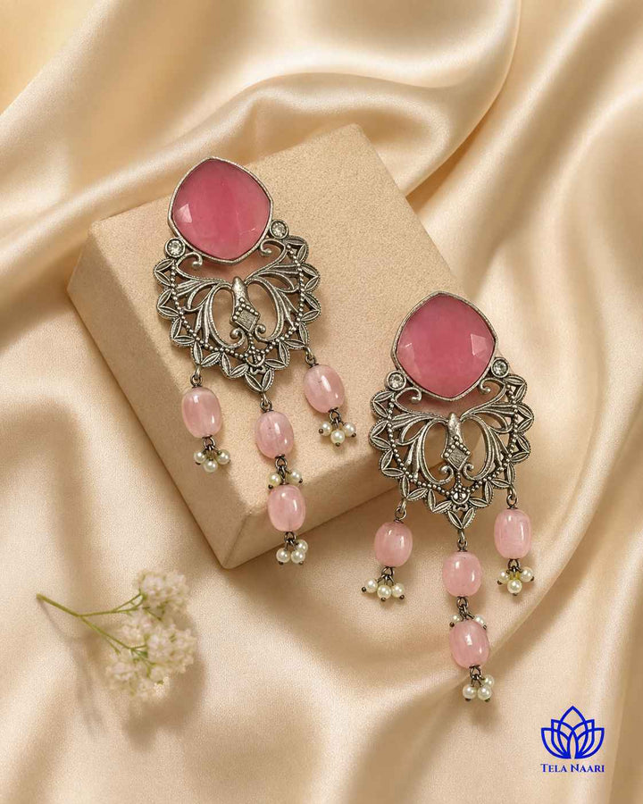 Brass construction supports the lightweight dangler design of this earring.