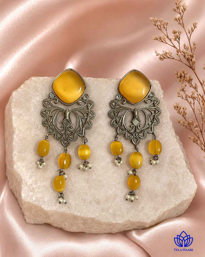 Radiant beadwork highlights the yellow tones of this dangler.