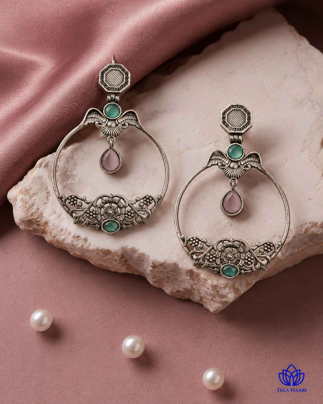 Brass construction supports the layered stone design of this earring.