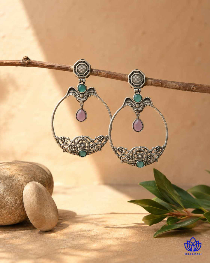 Glass bead detailing decorates the surface of this earring.