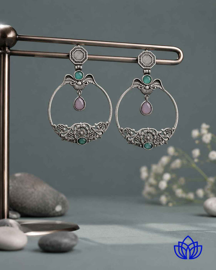 Push back closure secures this silver-plated stone earring in place.