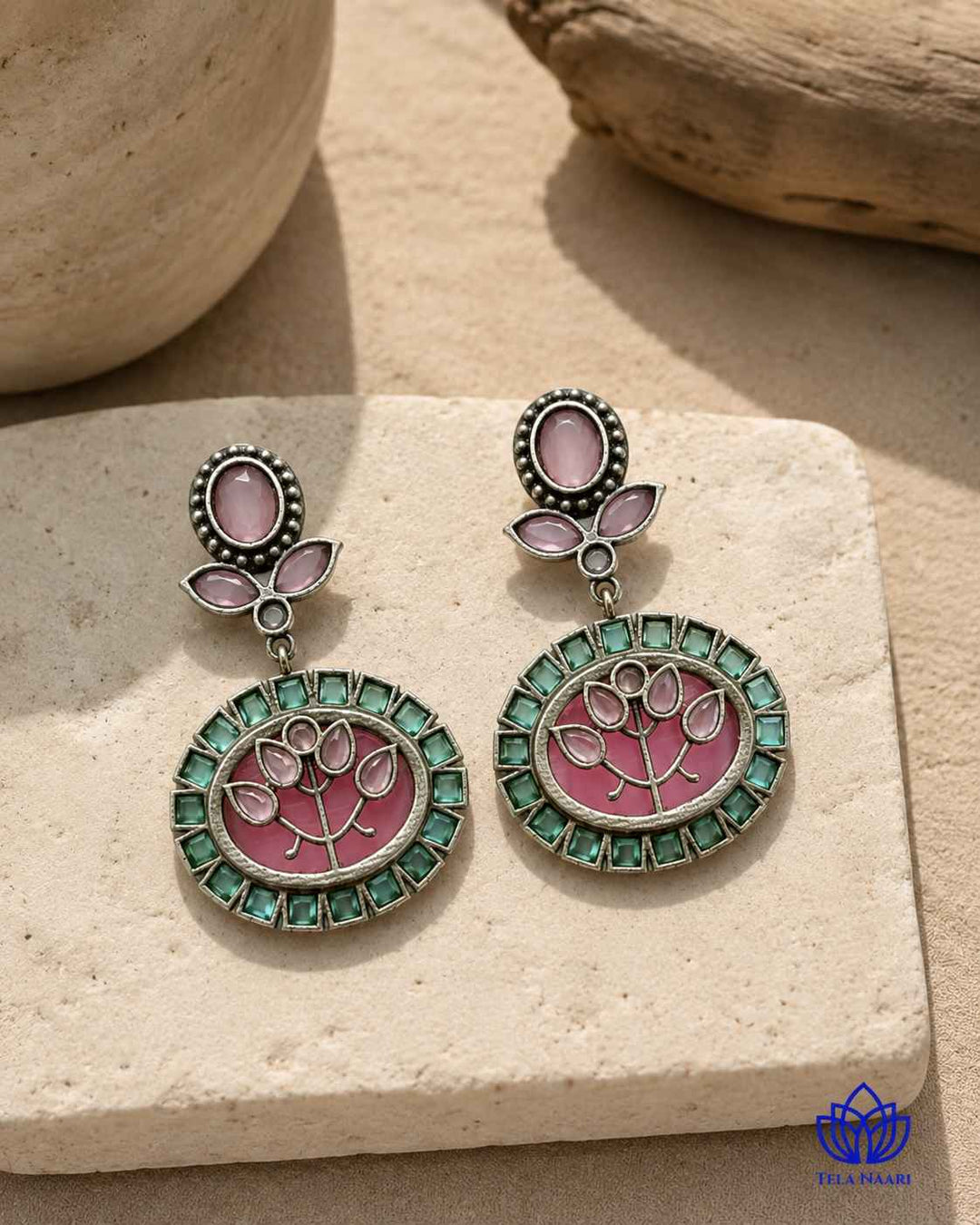 Vivid detailing pairs pink stone accents with oxidised silver.