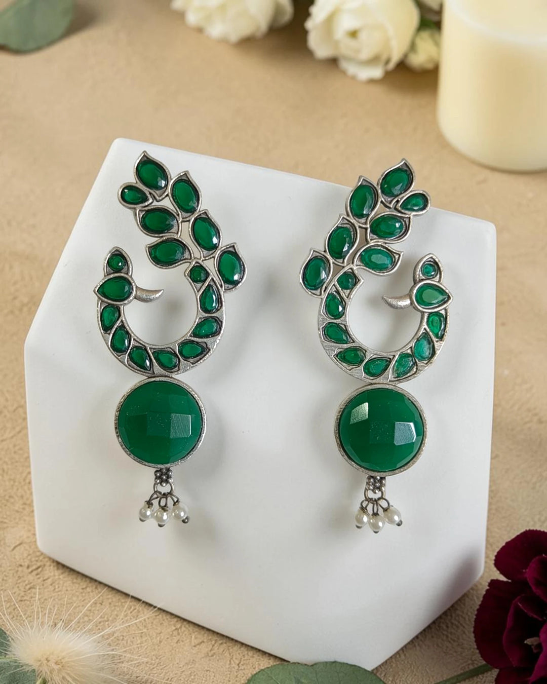 Stone and glass bead detailing decorate this green peacock earring.
