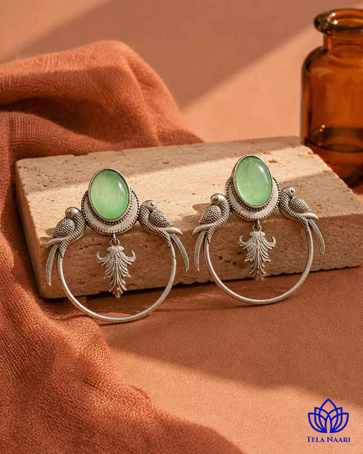 Playful parrot motif brings whimsical charm to this earring design.