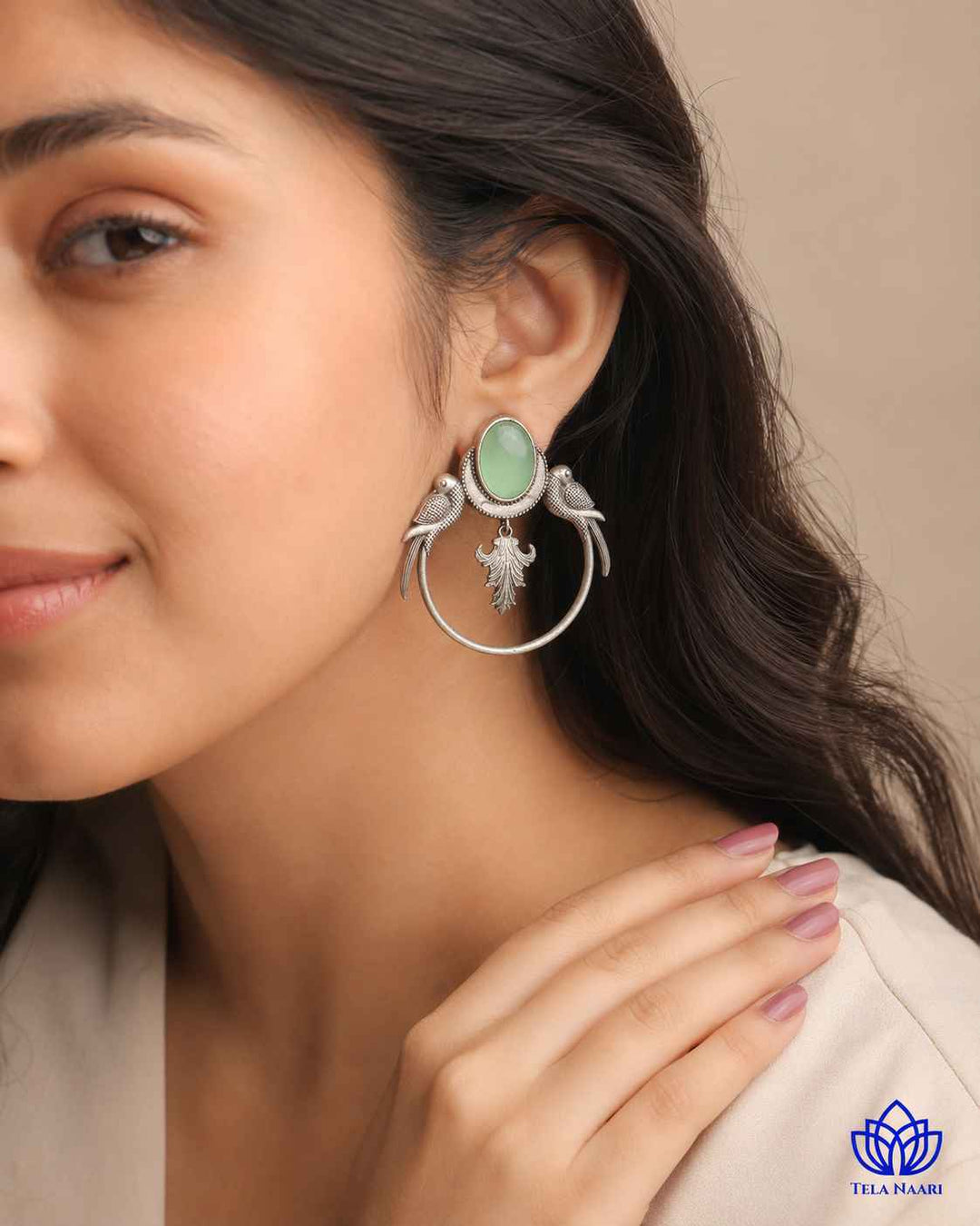 Polished surface highlights the parrot motif of this earring.