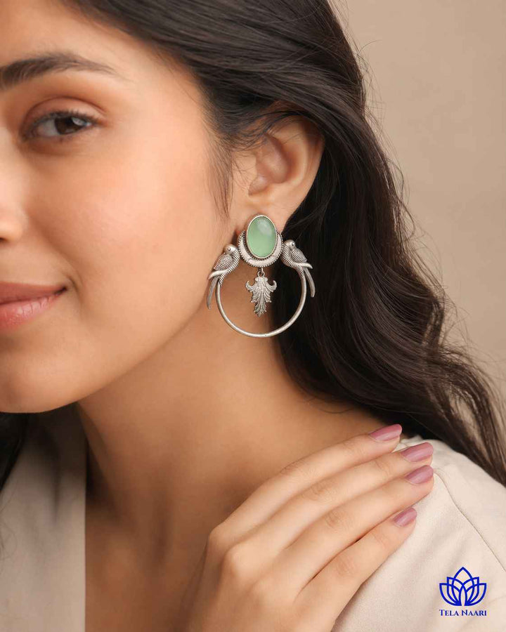 Polished surface highlights the parrot motif of this earring.