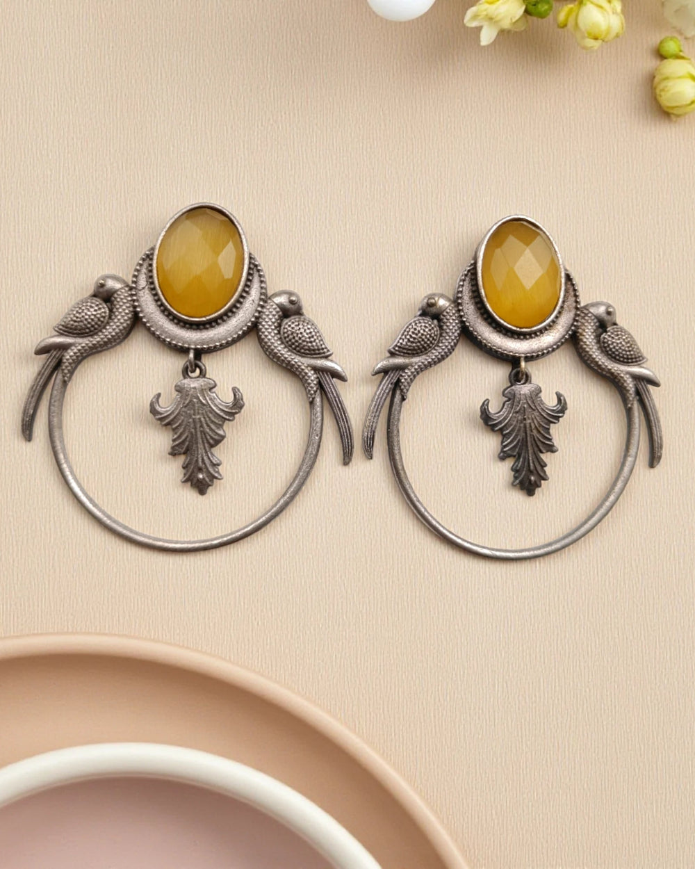 Silver-plated finish covers the surface of this yellow parrot earring.