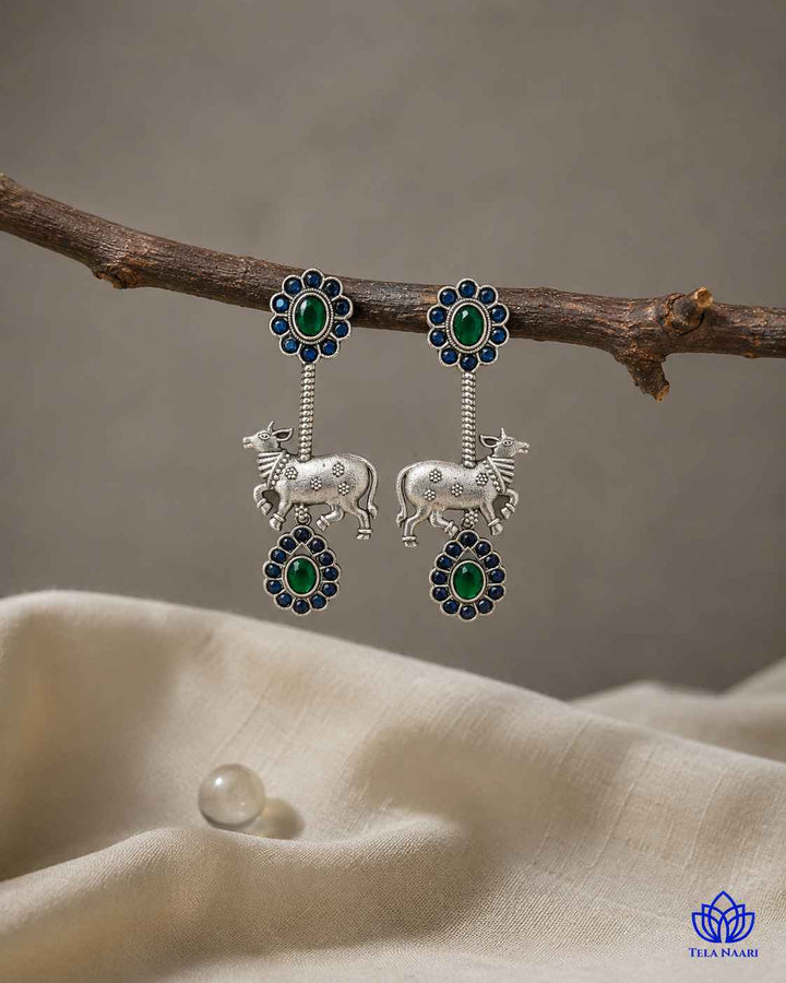 Handworked beadwork highlights the folk-art inspired earring design.