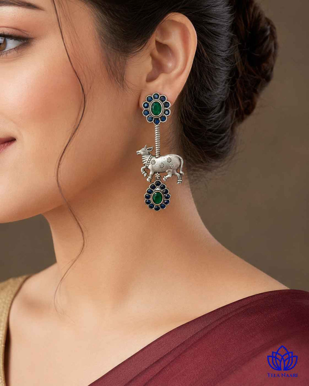 Folk-art Nandi motif brings quirky charm to this blue earring.