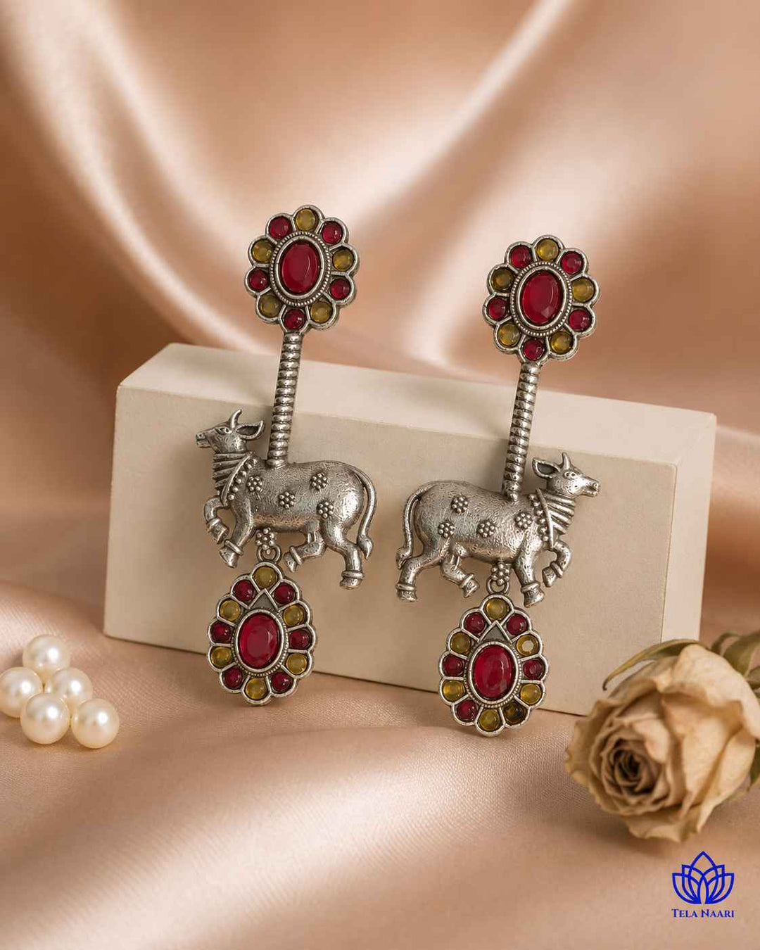 Brass construction supports the folk-art Nandi design of this earring.