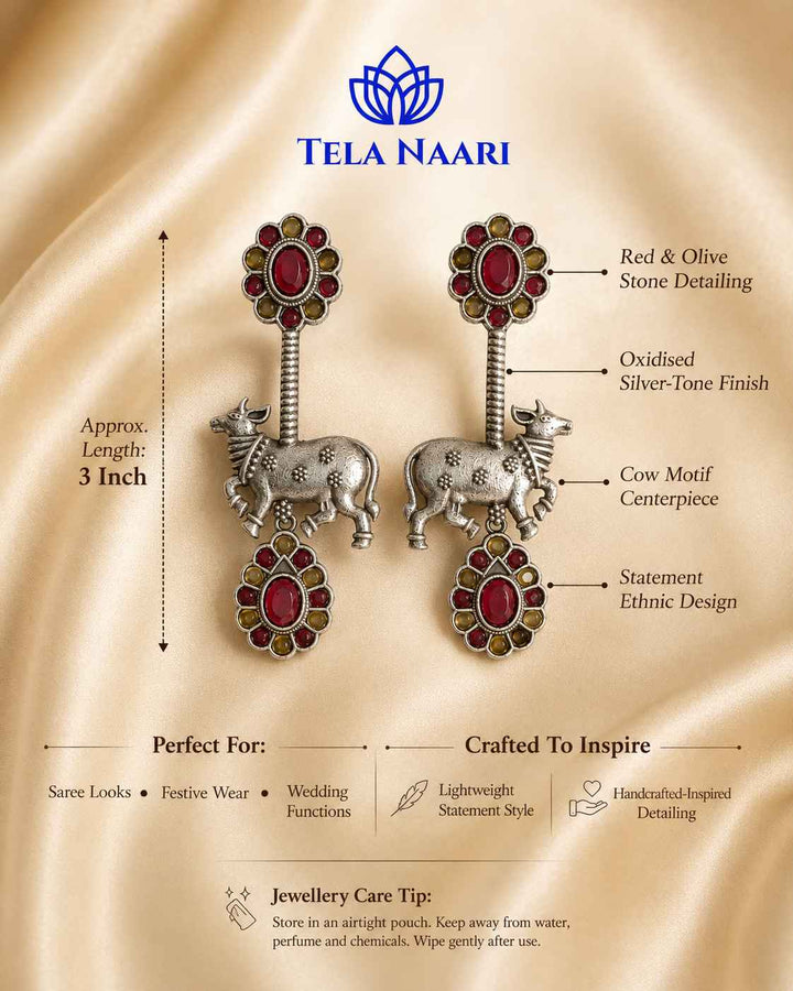 Quirky bull silhouette pairs red and yellow tones with silver plating.