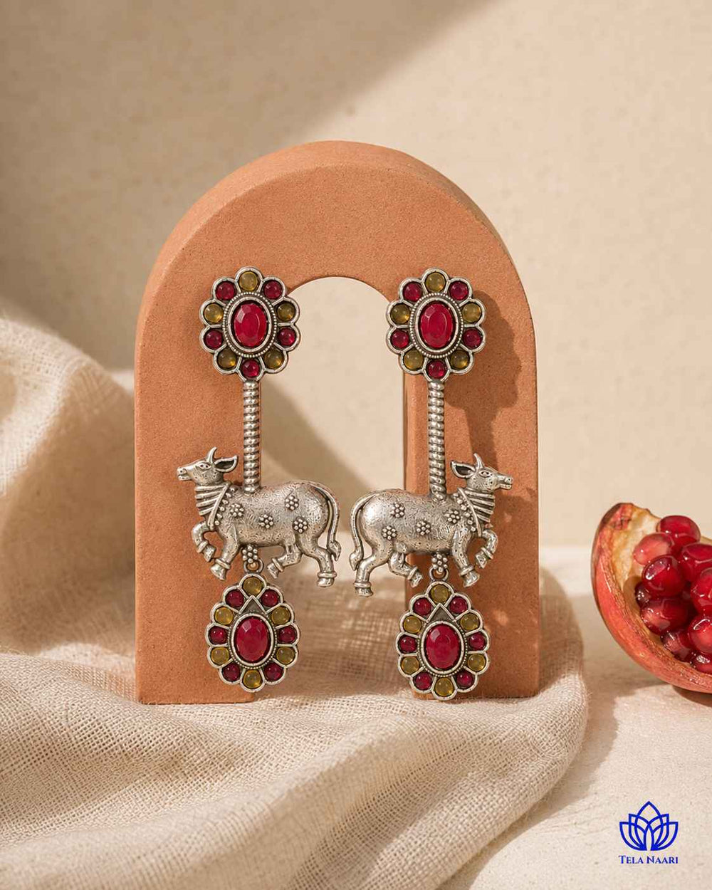 Silver-plated finish covers the surface of this Nandi earring.