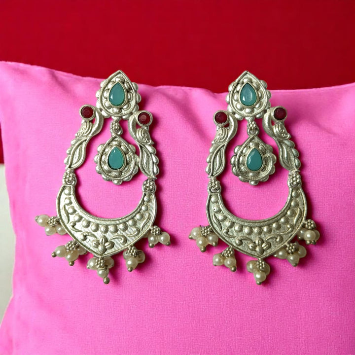 Brass construction supports the lightweight dangler design of this earring.
