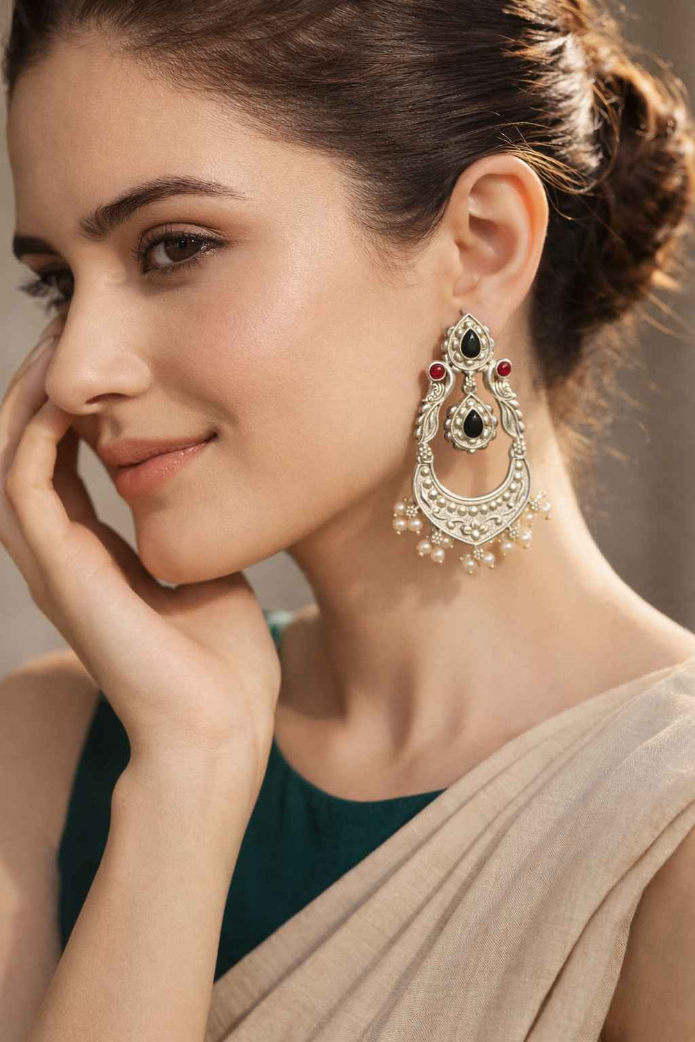 Red accents highlight the oxidised finish of this dangler earring.