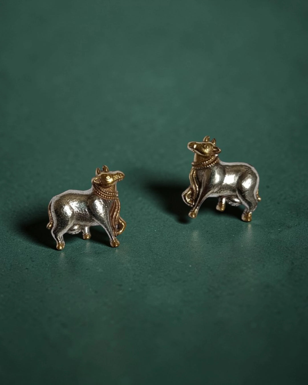 Brass construction supports the lightweight cow-motif stud design.
