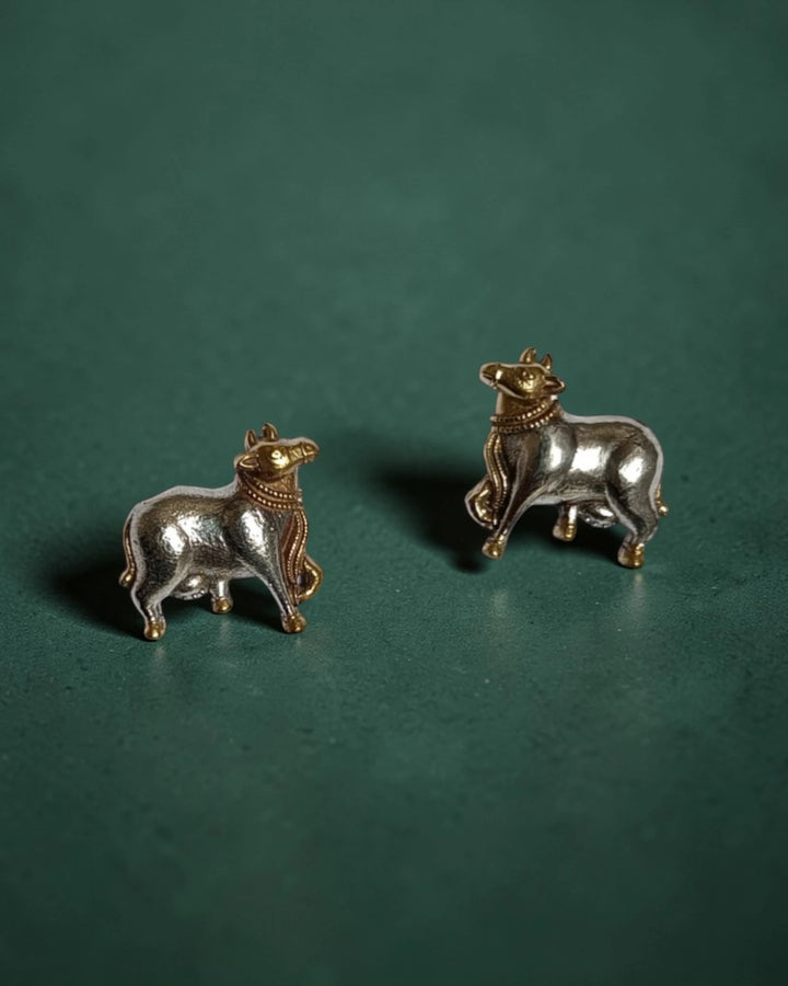 Brass construction supports the lightweight cow-motif stud design.