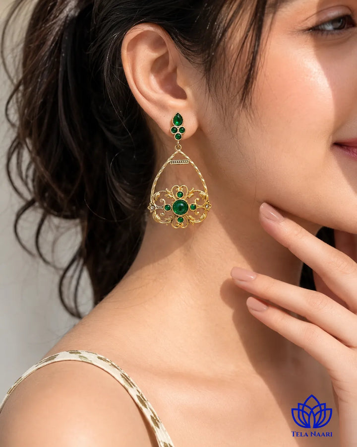 Modern elegance defines the silhouette of this green stone earring.