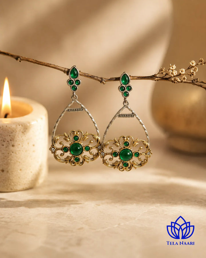 Timeless drop silhouette pairs green stone with dual-tone metal.