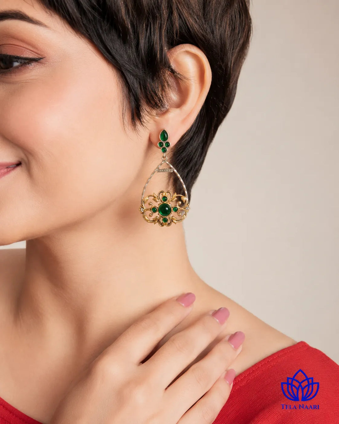 Versatile design pairs a royal green stone with silver plating.