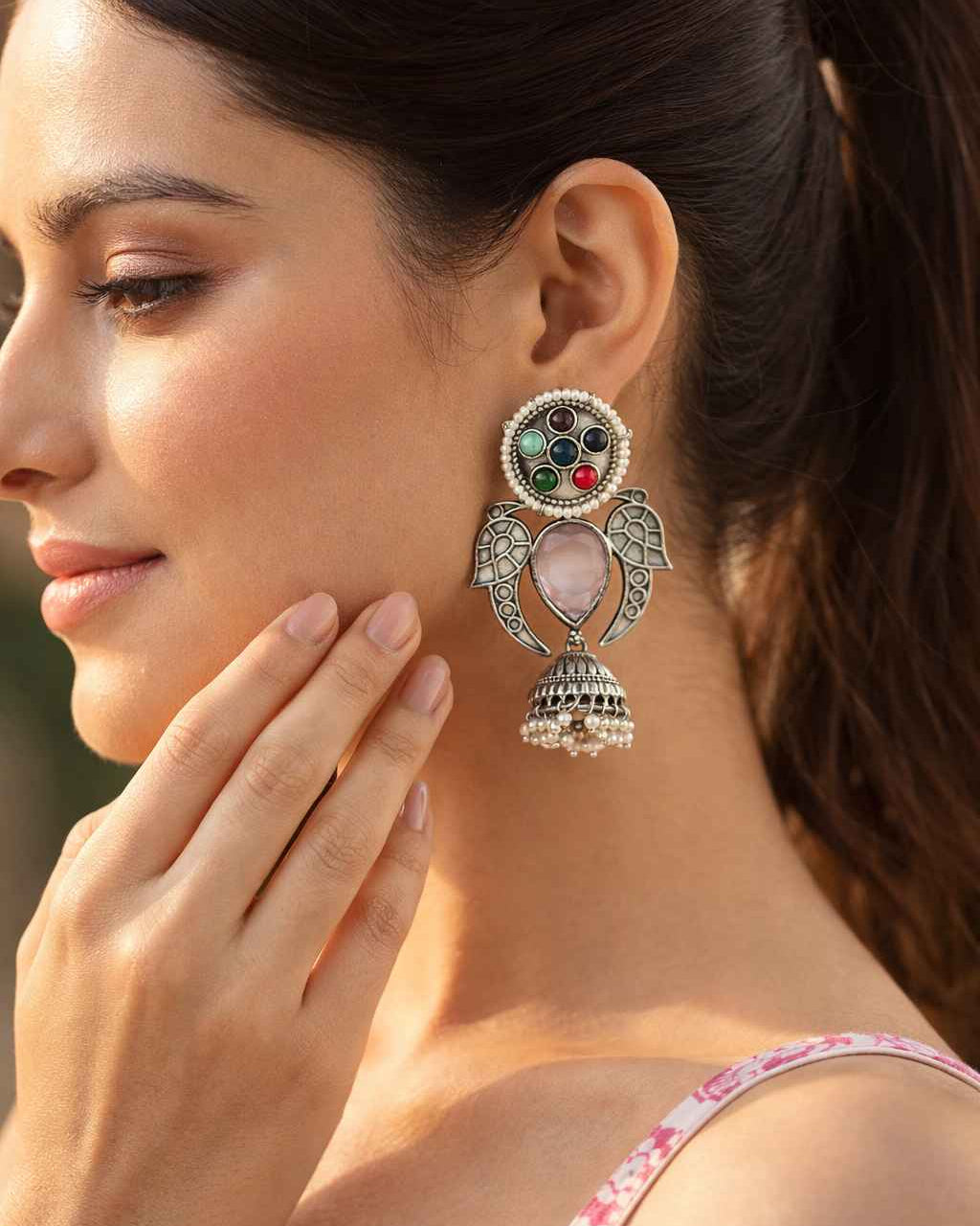 Antique jhumki craftsmanship shapes the silhouette of this earring.