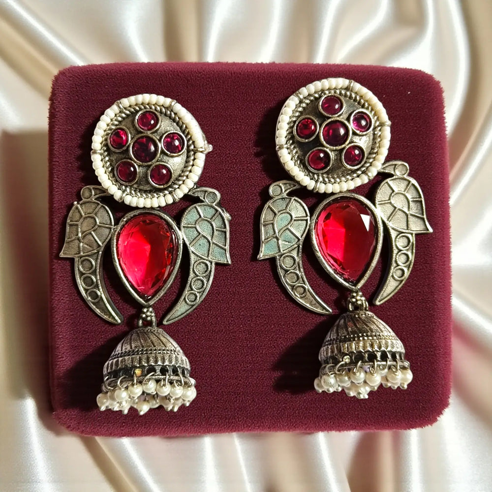 Silver oxidised polish covers the traditional bell shape of this earring.