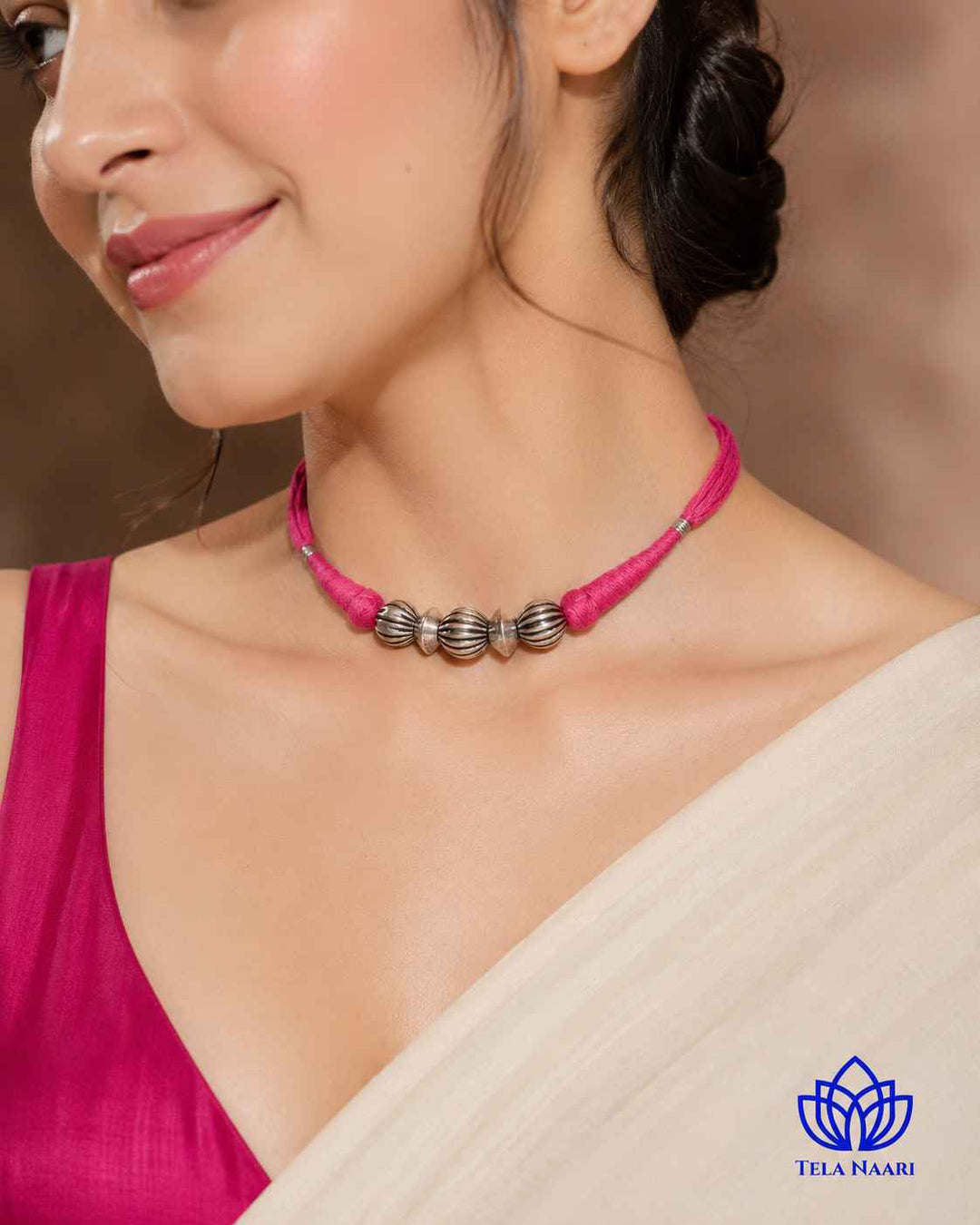 Delicate thread detailing shapes the silhouette of this choker.