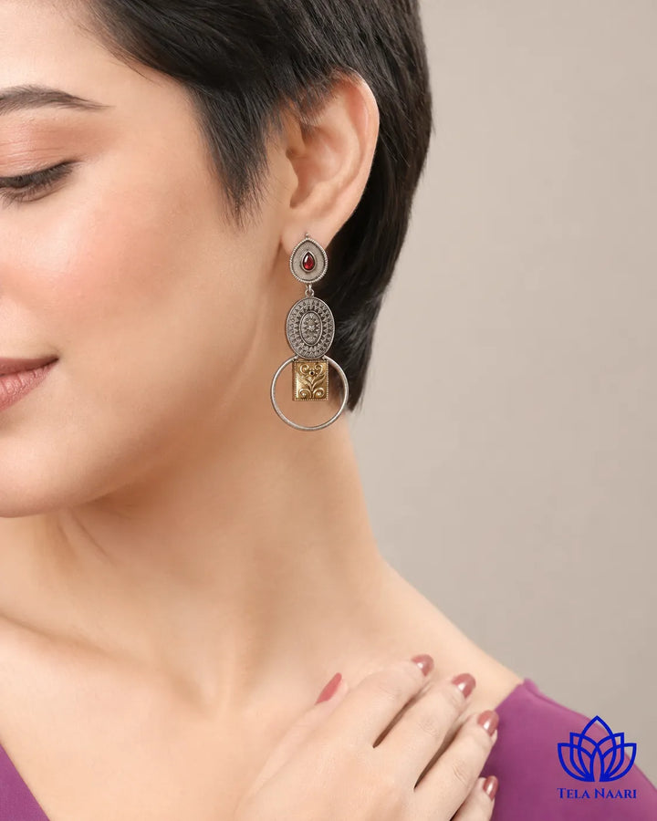 Contemporary edge defines the metallic contrast of this earring.