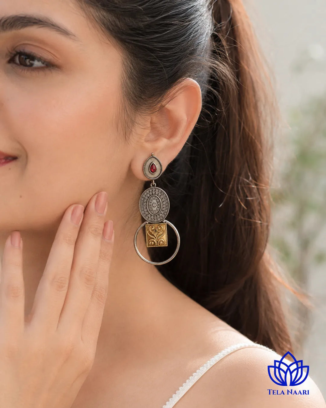 Refined touch defines the dual-tone silhouette of this earring.