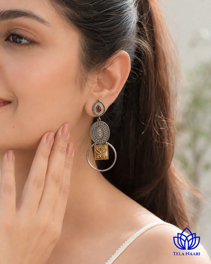 Refined touch defines the dual-tone silhouette of this earring.
