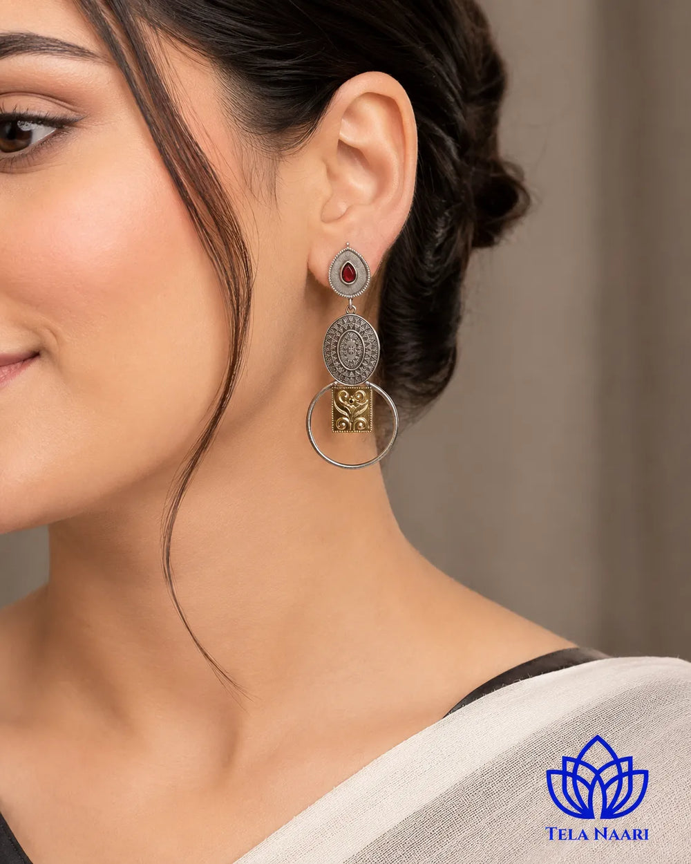 Warm metallic tones blend with cool silver in this earring.