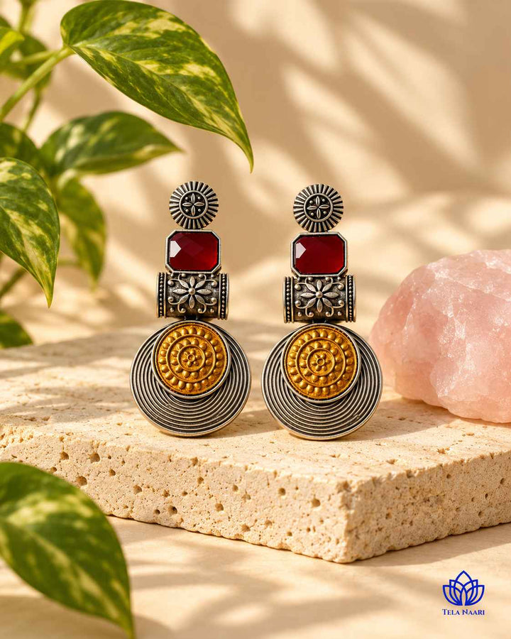 Layered plating gives this red earring its bold structure.
