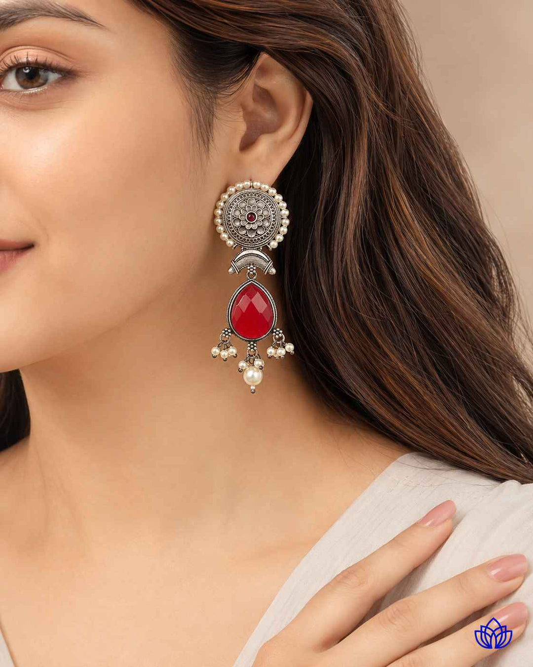 Artificial stone detailing sits at the centre of this red earring.
