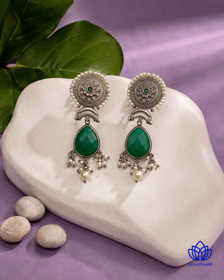 Brass construction supports the soft teardrop shape of this earring.