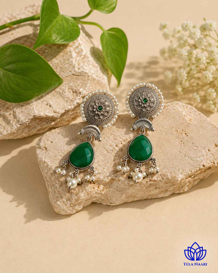 Delicate stone work highlights the design of this teardrop earring.