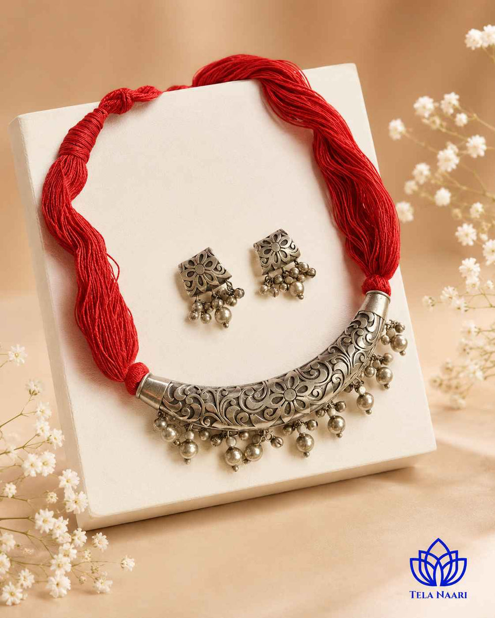 Antique finish covers the surface of this thread necklace.